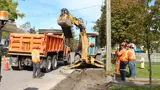 Road workers and equipment working on a road