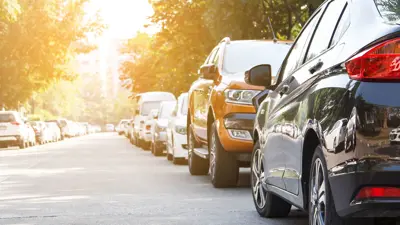 Many cars parked on a street