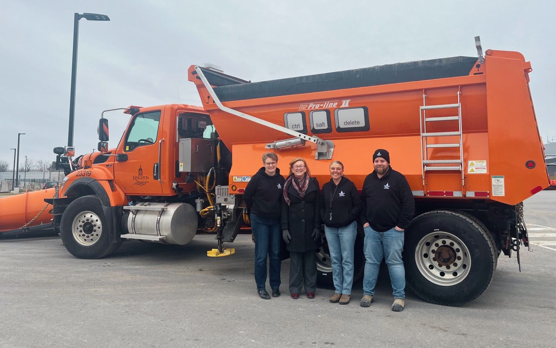 City Councillor Conny Glenn joins Public Works staff in front of Ctrl + Salt + Delete snowplow.