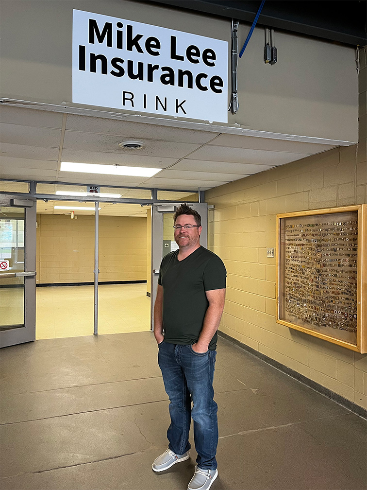 Mike Lee Insurance Rink. Mike Lee standing in front of newly-named rink.