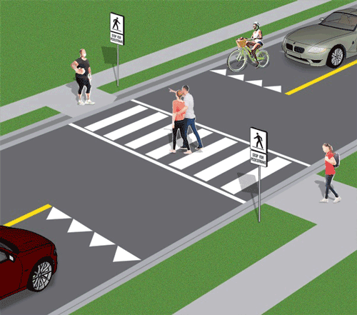 Pedestrians crossing at a Type D crossover while vehicles wait at the yield line.