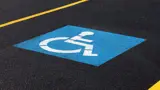 Accessible symbol painted into the asphalt in a parking spot