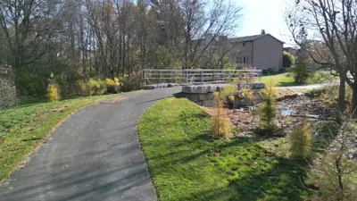 A park trail going over a bridge