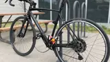 A black bike with a lock outside a building