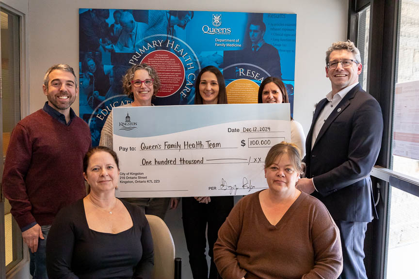 Kingston city councillors Brandon Tozzo and Gregory Ridge presented Queen's Family Health Team with a $100,000 cheque through the City's Primary Care Clinic Expansion Grant.