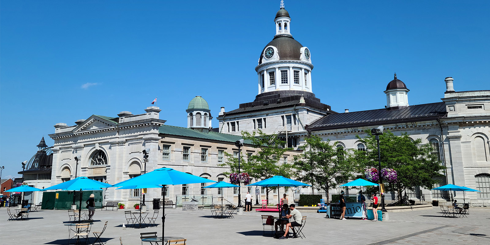 Kingston Market Square with umbrellas and tables on a sunny day
