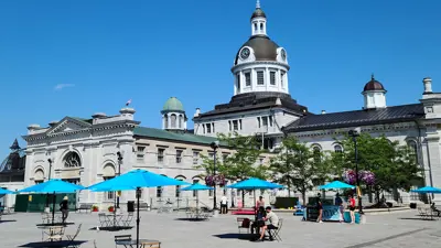 Cityhall with umbrellas and tables on a sunny day