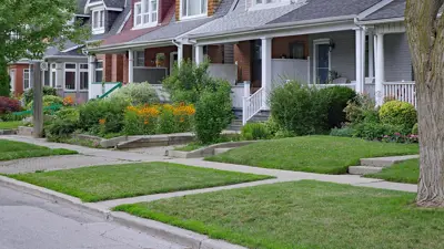 A row of houses with tidy front lawns