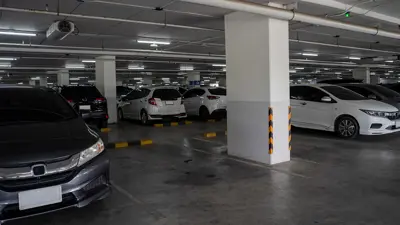 Indoor parking lot showing various vehicles parked