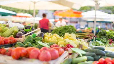 Many vegetables on a stall outside in a market