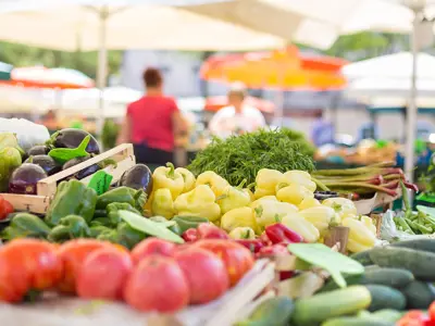 Many vegetables on a stall outside in a market