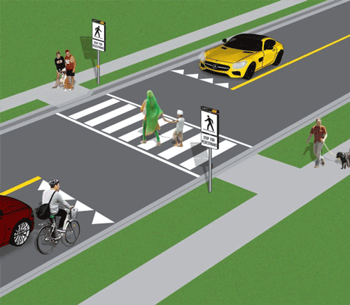 Pedestrians crossing at a Type C crossover while vehicles wait at the yield line.
