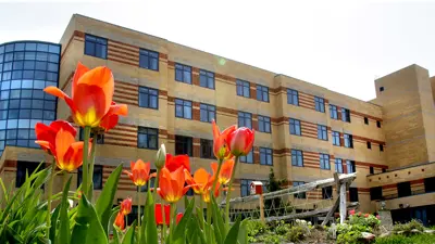 Rideaucrest building with flowers in the foreground