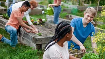 A group of diverse people working together in a garden