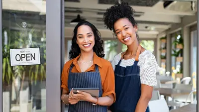 Two business owners standing by the entrance of their store