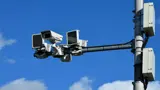 Traffic cameras with a blue sky behind