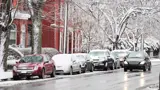 Winter street with snow and parked cars