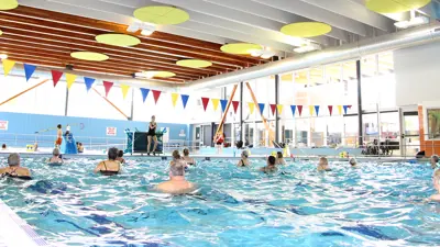 People swimming in an indoor pool.