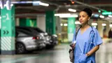 A nurse in an underground parking lot