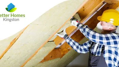 A person in a hard hat working with insulation in a home