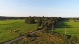 A drone image of rural fields and trees in the Kingston area