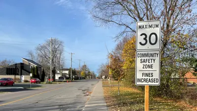 Kingston street with a Maximum 30, Community Safety Zone, Fines Increased sign on the side or the road